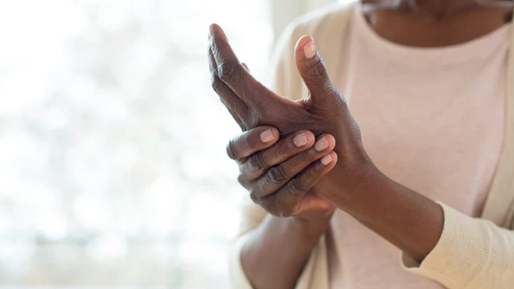 Woman holding sore hand 