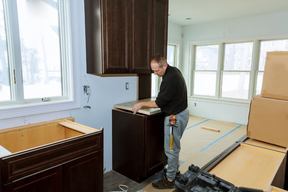 A person installing laminate countertops.