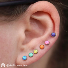 Ear pierced with a Rainbow assortment of Bezel Set Cabochons