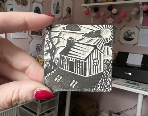 A small 5cm x 5cm lino cut of a house