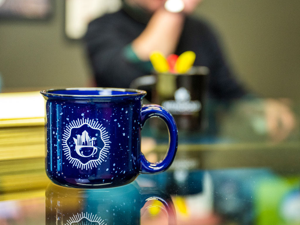 A mug with Metropolis Coffee branding on a table.