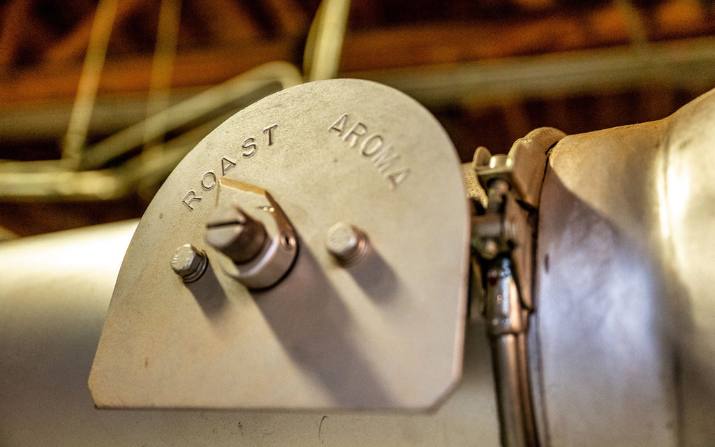 A lever on a coffee roasting machine used for controlling temperature.
