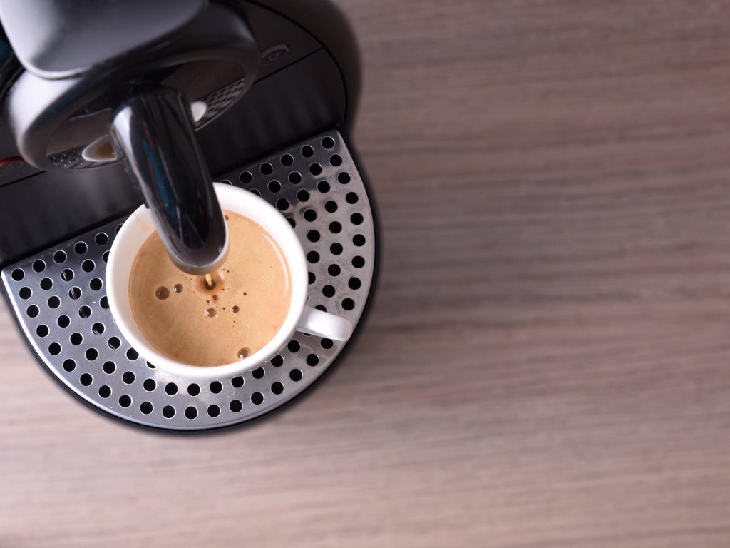 Brewing espresso capsules, not wholesale coffee pods, in a Nespresso original line brewer.