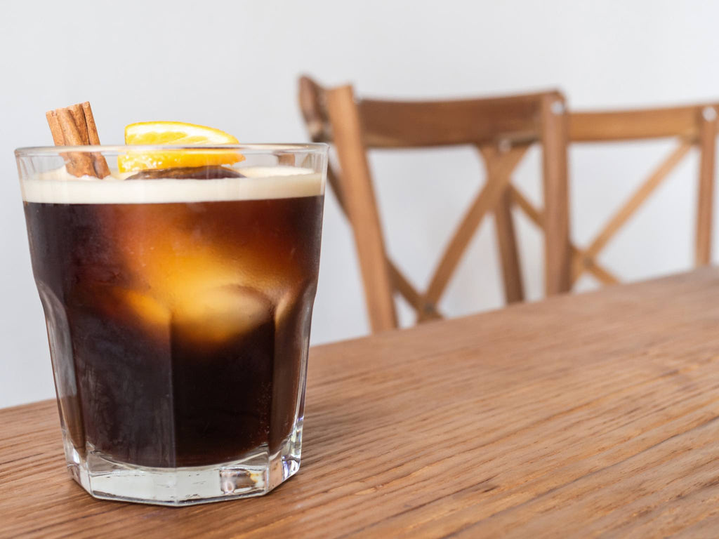 An espresso martini on a café countertop.