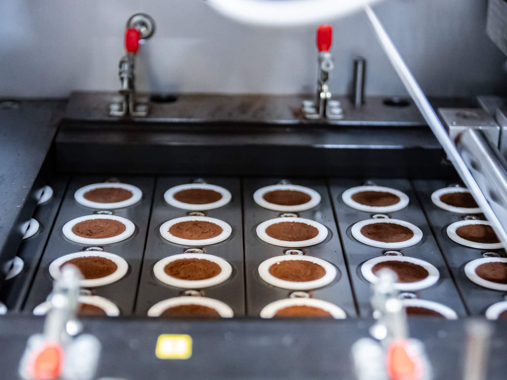 Co-packing coffee capsules using a filling machine.