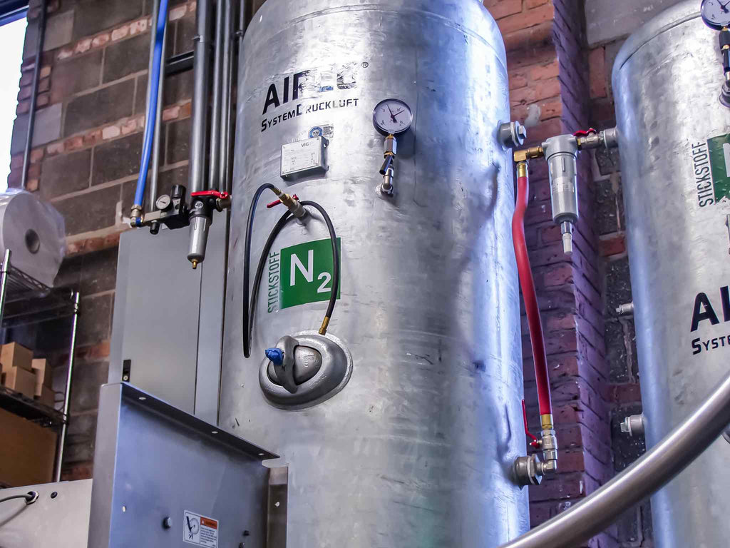 A tank of nitrogen gas used for flushing wholesale coffee capsules.