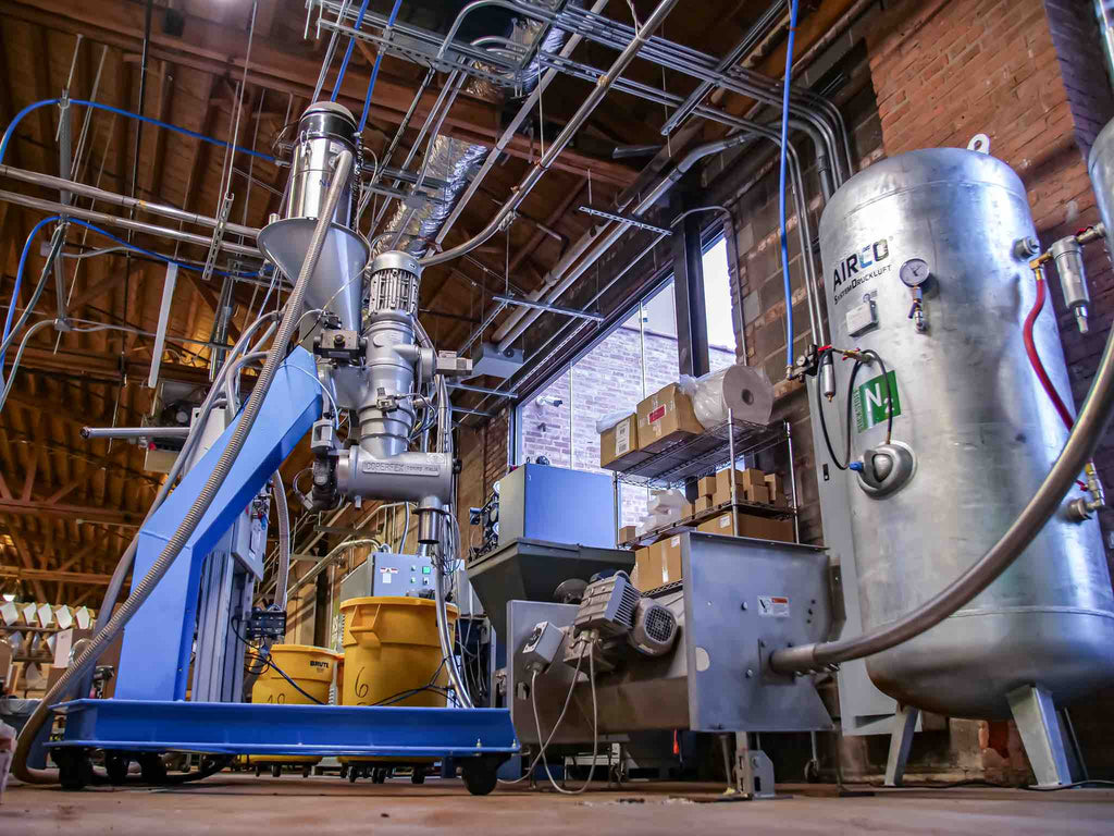 Nitrogen flushing private label coffee capsules at a factory.