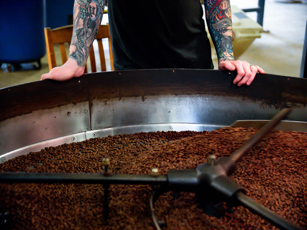 A coffee professional roasting coffee for coffee pods.