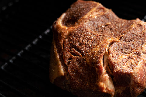 Image of a Pork Shoulder near completion after several hours of cooking at low temperatures in a smoker