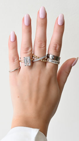 Image of hand with rings on finger. One being a lab-grown diamond engagement ring | Buchroeders Jewelers