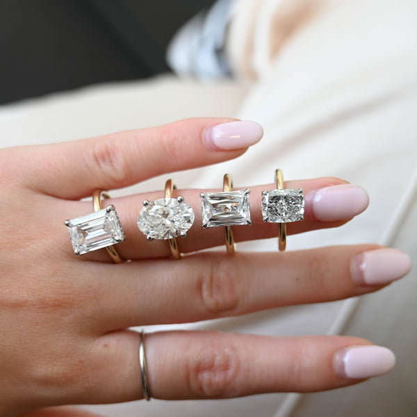 Lab grown engagement rings stacked on a finger