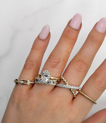 Image of oval diamond engagement with fashionable dainty stackable rings | Buchroeders Jewelers