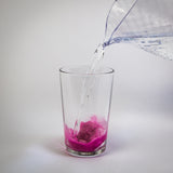 recuperol mixed berry electrolyte powder with water poured into glass