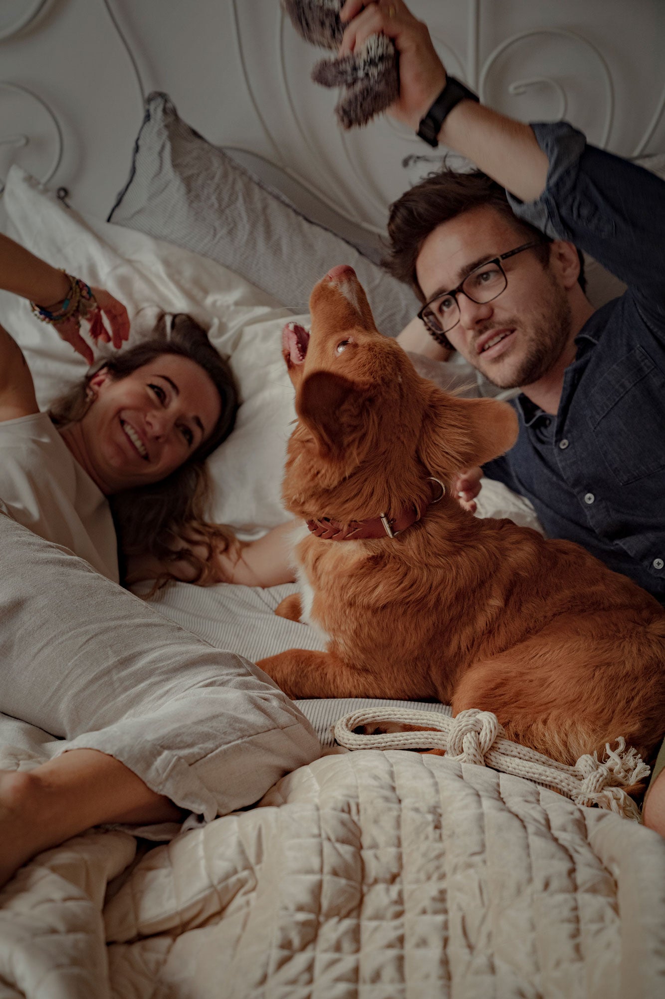 Couple playing with their Tolling Retriever on a Bismarck & Co blanket