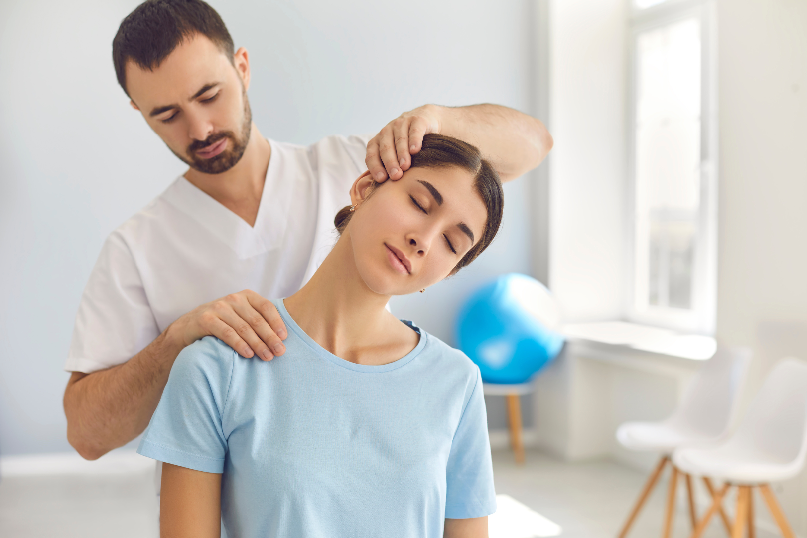 A chiropractor adjusting a patient’s back