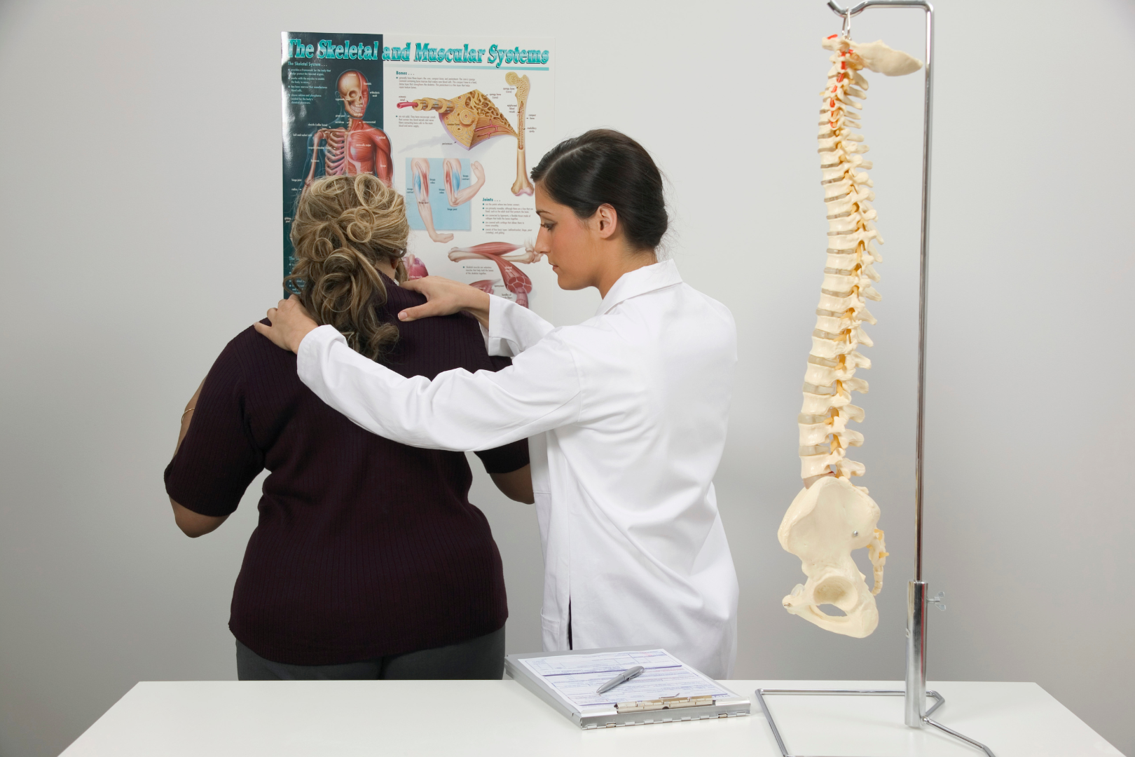 A chiropractor examining a patient's neck