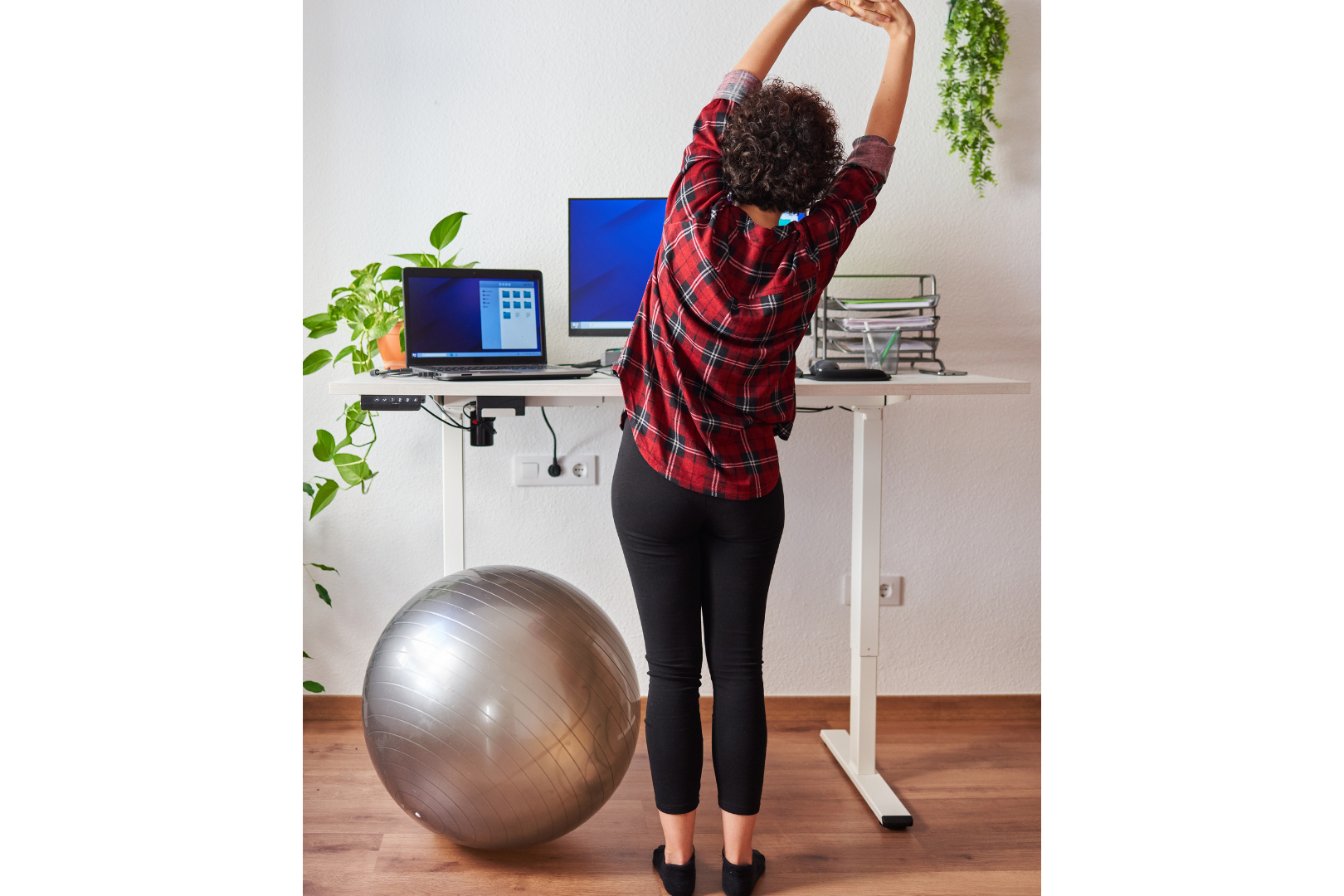 Sitting with proper posture, standing at a standing desk.