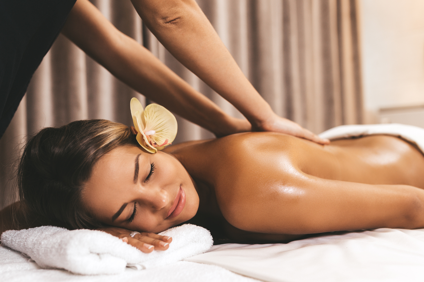 A massage therapist working with a female client