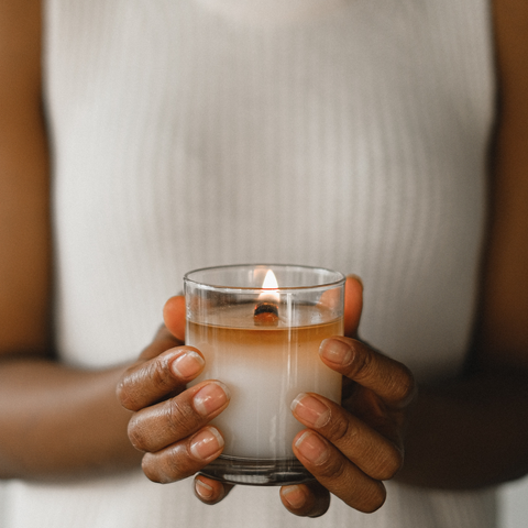 woman holding glass candle 