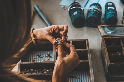 Hands putting on three stackable rings