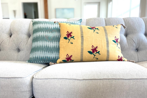 Sustainably made throw pillows on modern grey couch