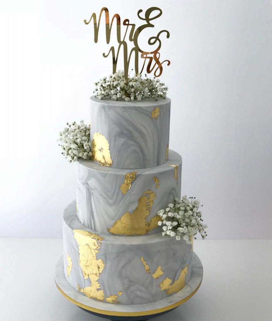 edible gold leaf on a concrete look 3 tier cake