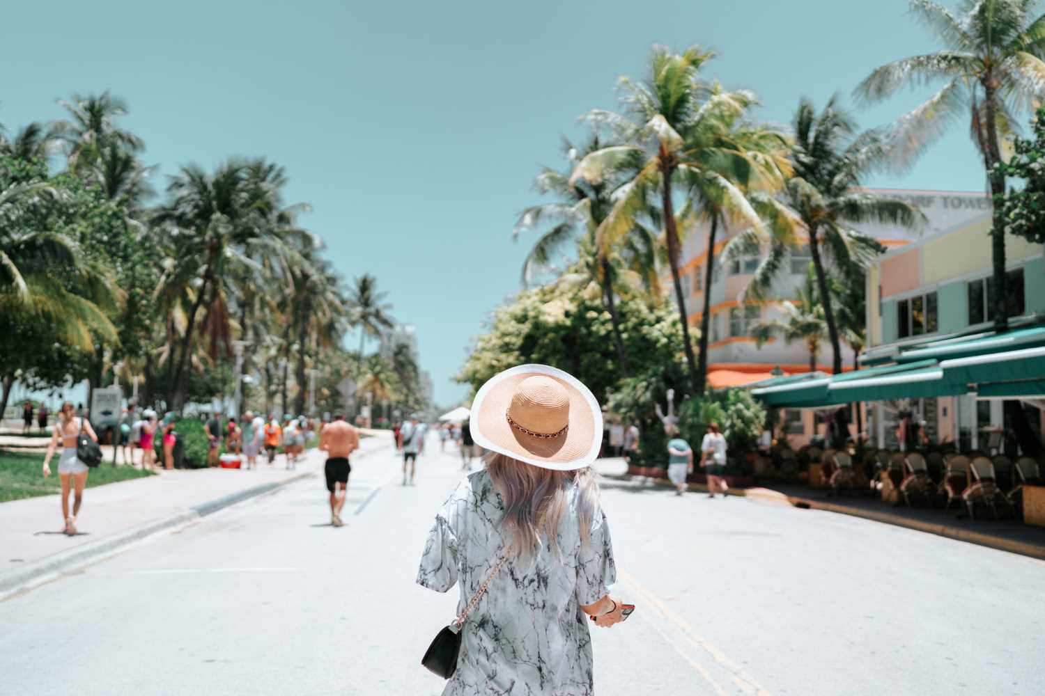 Beautiful woman walking along Ocean Drive