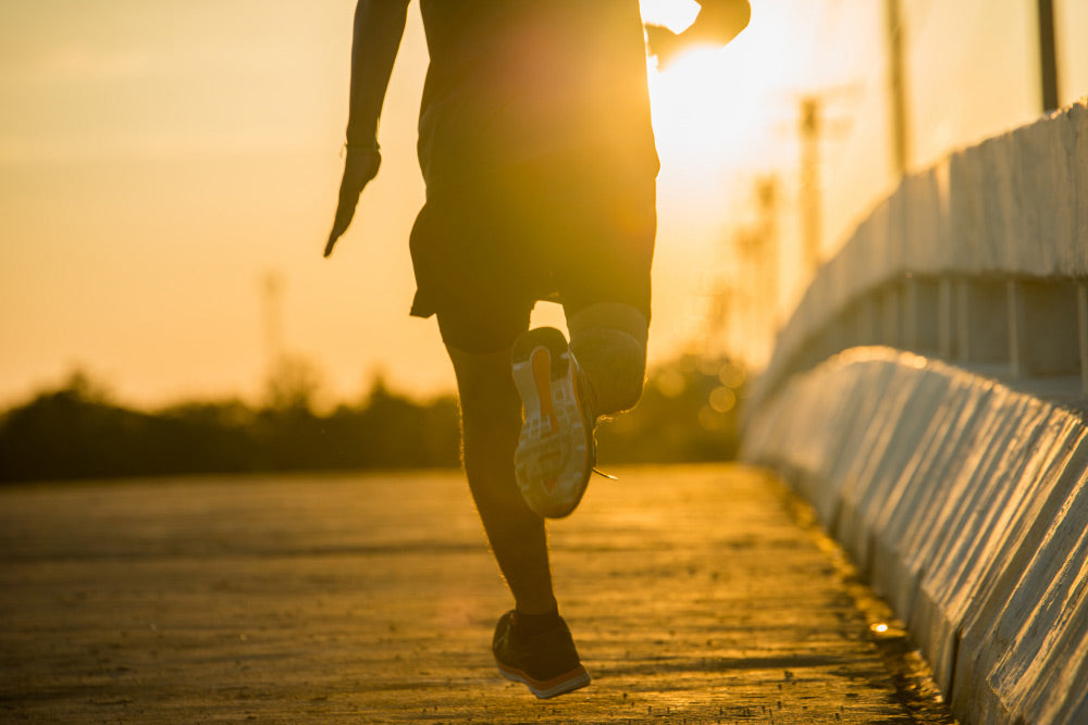 Runner at dawn on a causeway