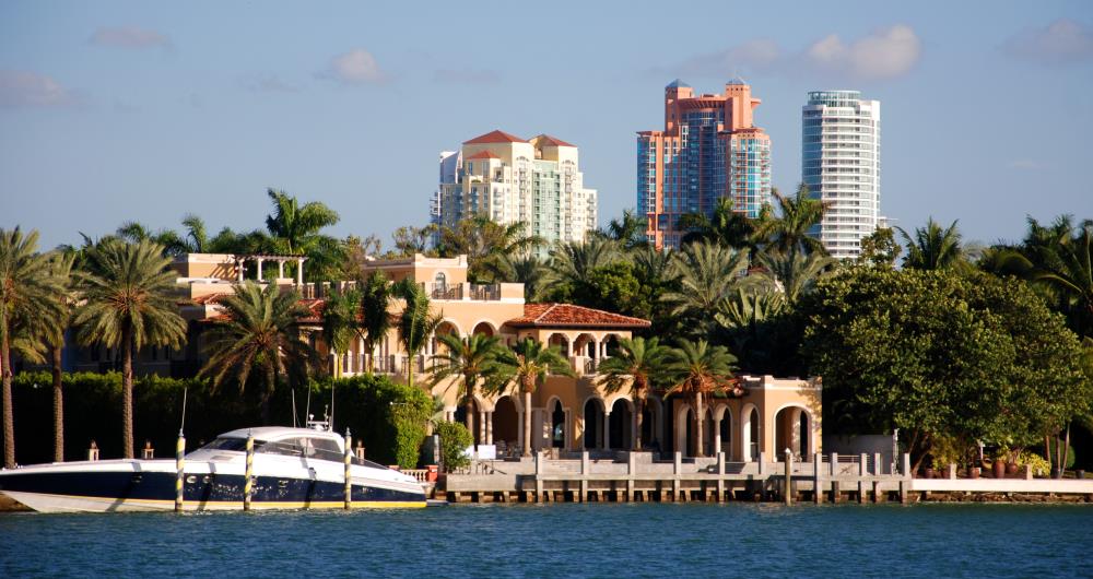 Luxurious waterfront home in Miami Beach with the Portofino Tower as a backdrop