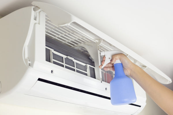 Misting systems vs traditional cooling methods - cleaning an air conditioner.