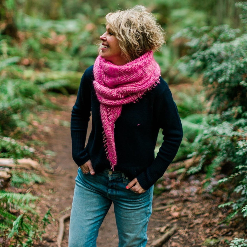 Sarah wearing a pink and cream marled garter stitch shawl.