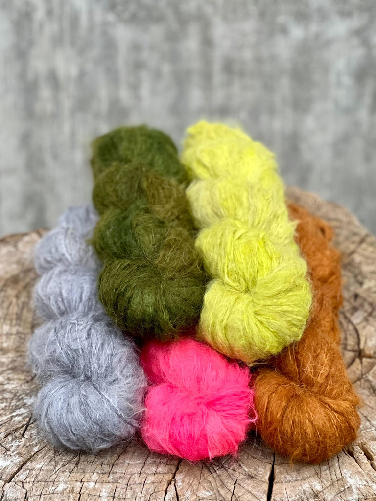 Five skeins of yarn in a stack.