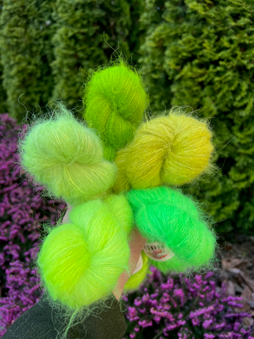 A bouquet of five bright green yarn skeins.