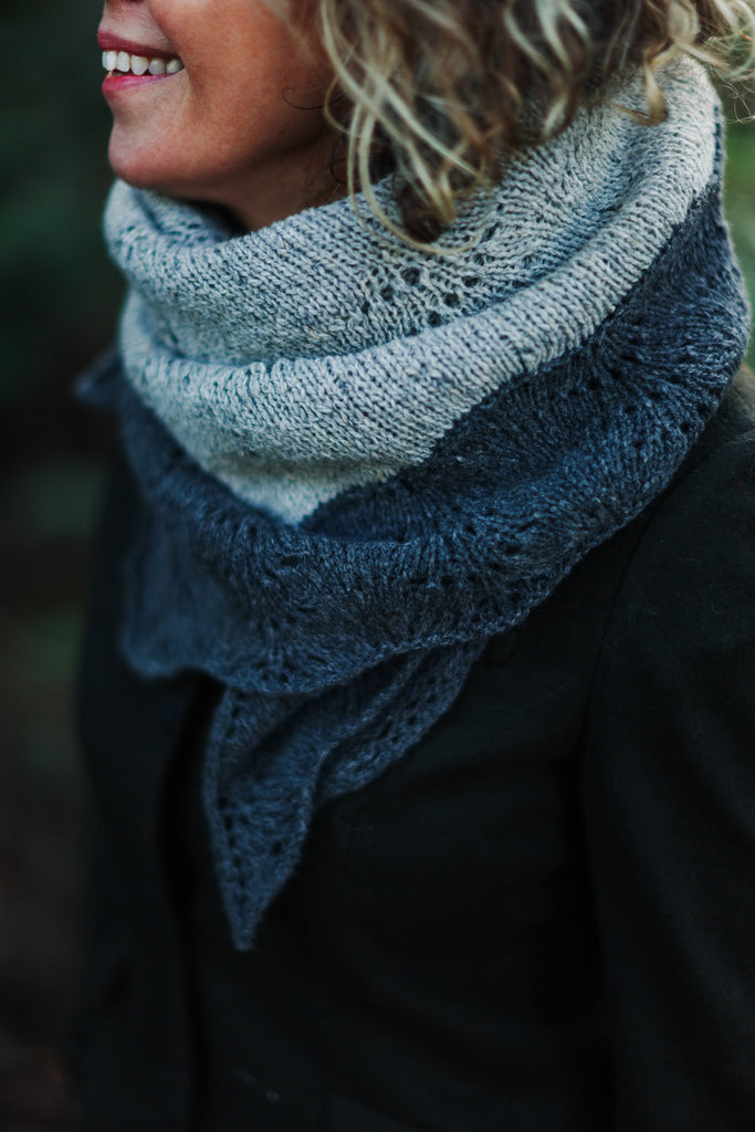 Sarah wearing a two color grey shawl tucked around her neck.