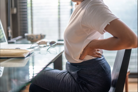 picture showing someone with back pain caused by sitting too long