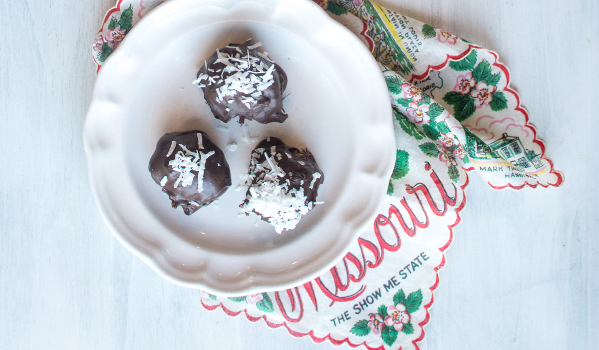Cannabis infused peppermint coconut date balls on vintage white plate with Missouri handkerchief 