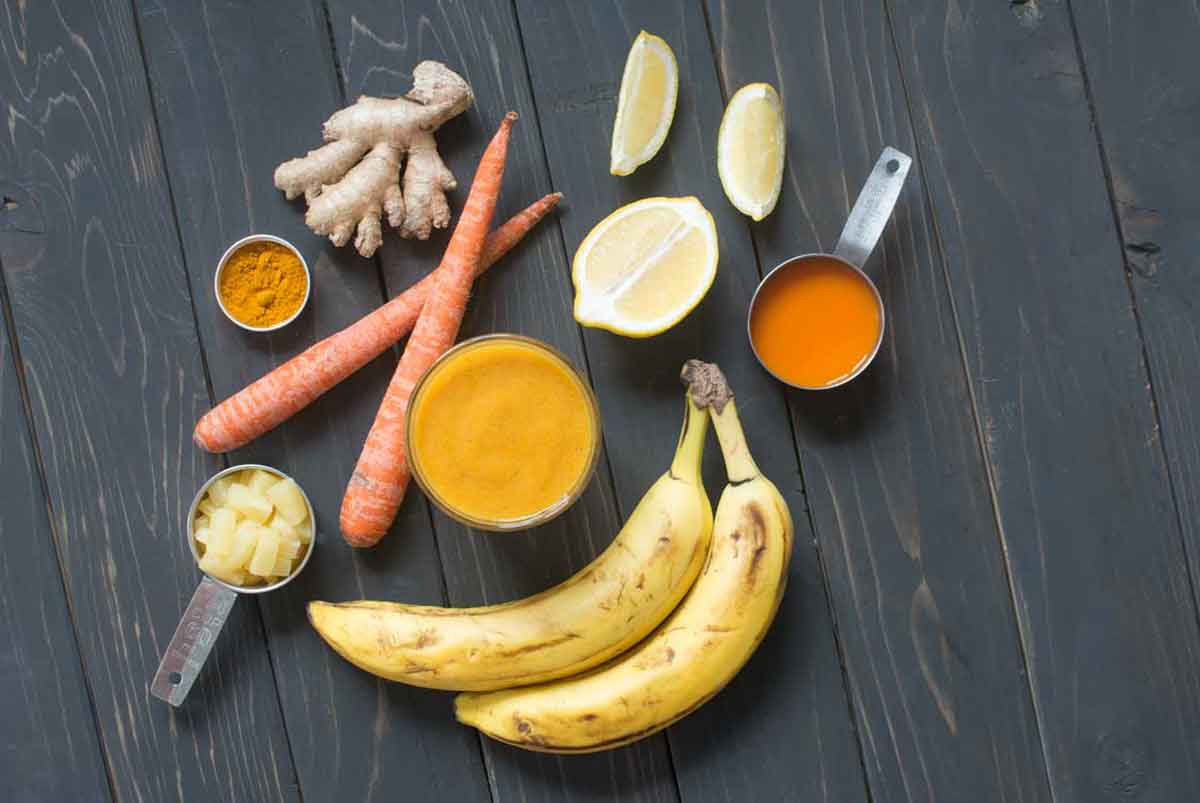 Flu fighter smoothie with bananas, carrots, turmeric, ginger, lemon, pineapple
