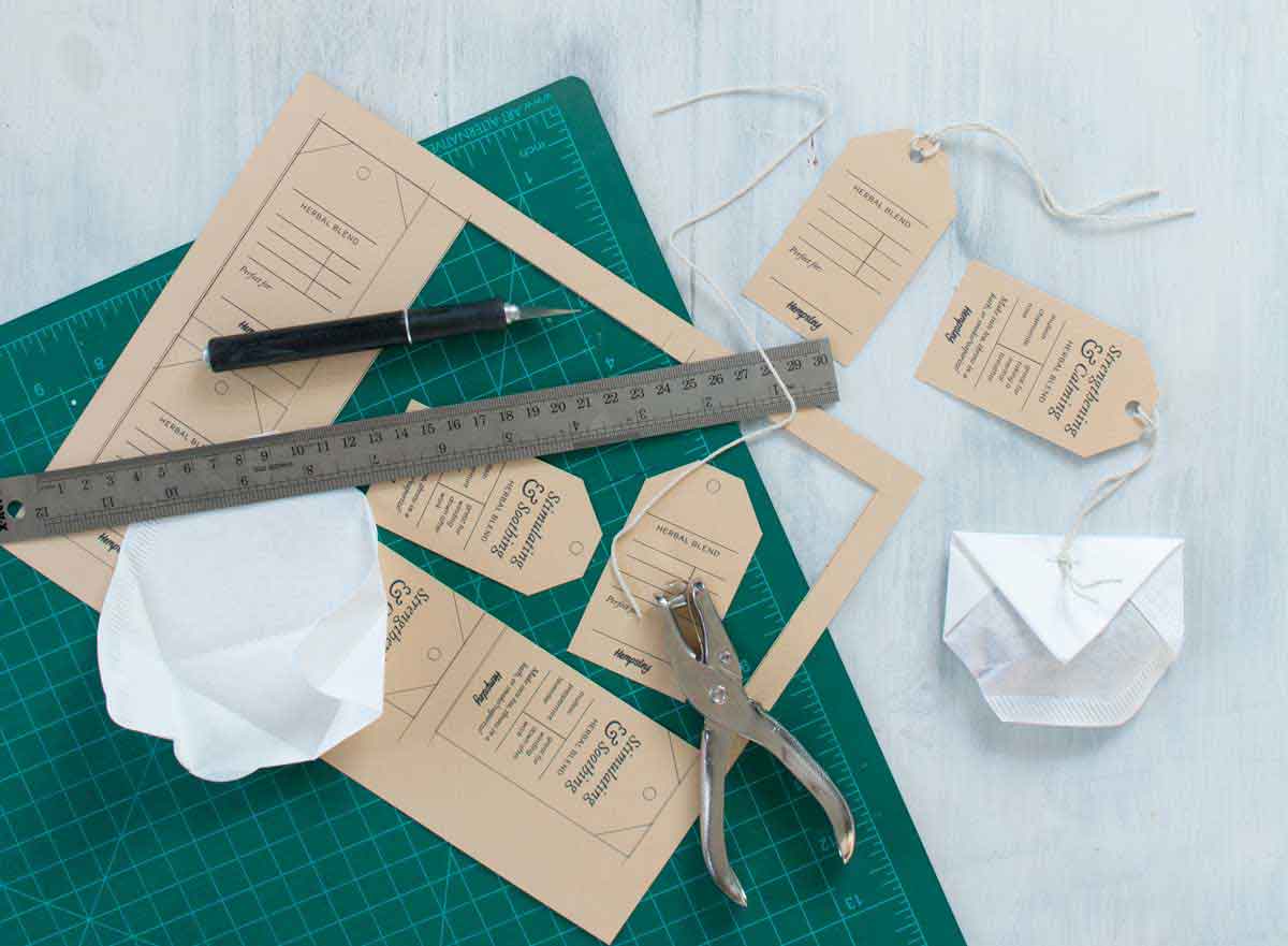 Cutting mat with printable tea tags, ruler, xacto knife and DIY teabag 