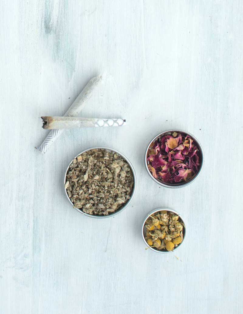 Rose, mullein, and chamomile next to herbal joint cones