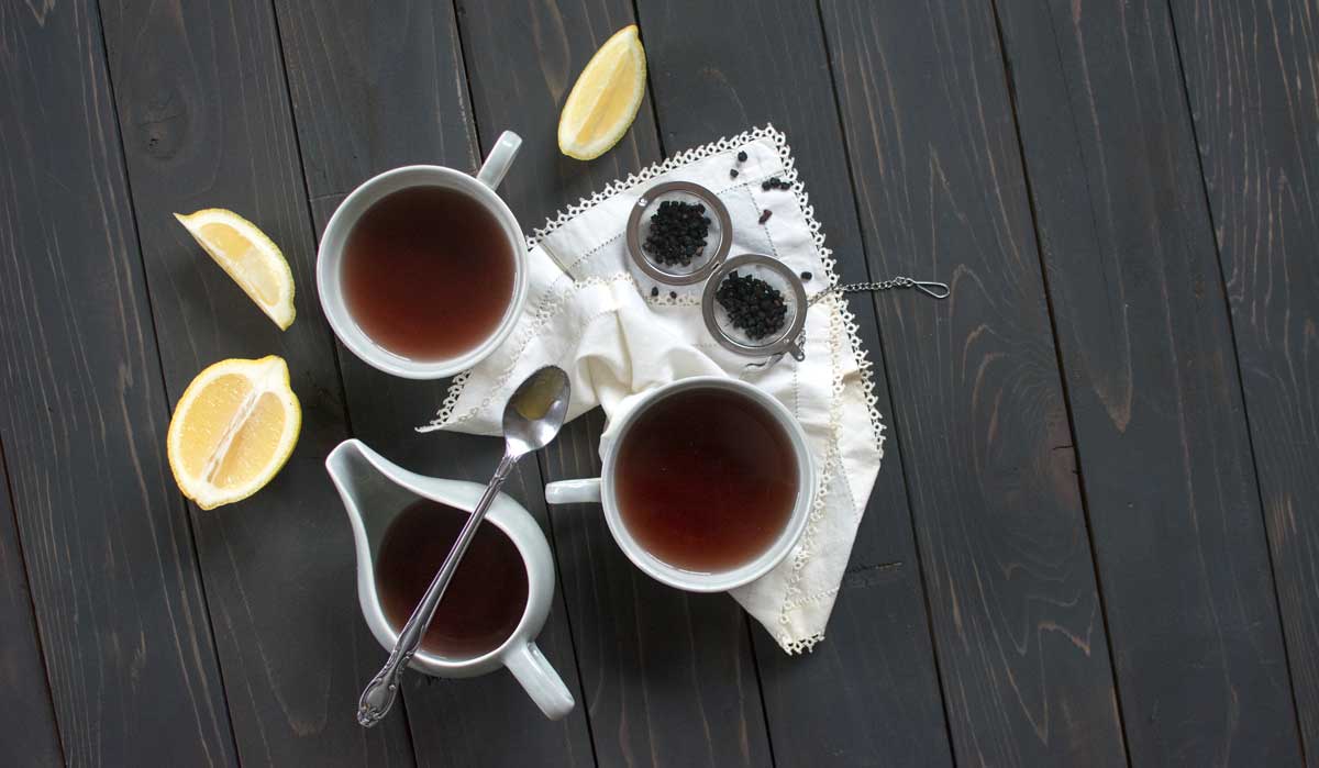 Limonene tea styled with lemon, elderberry, spoon, vintage napkin