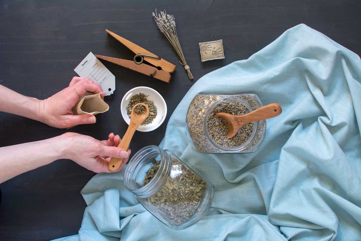 Woman making herbal blend for smoking, vaporizing, making into tea or bath soak