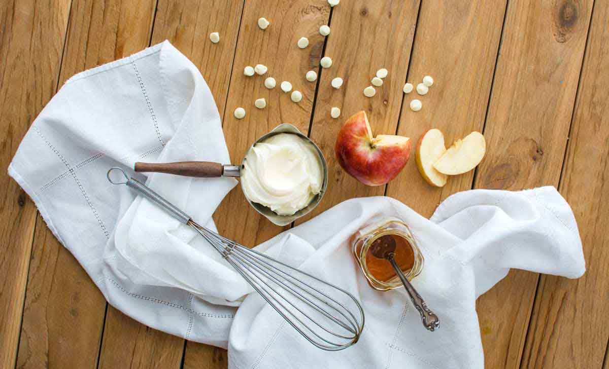 Decadent fruit dip recipe with white chocolate chips, honey, vanilla, apples