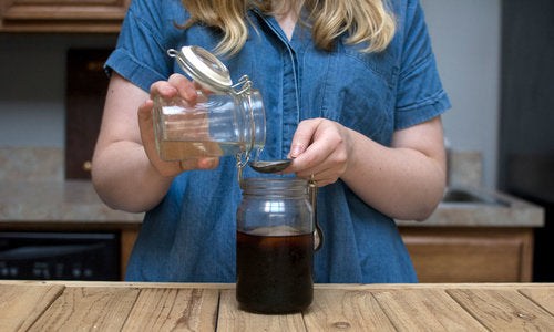 Pouring infused oil into coffee