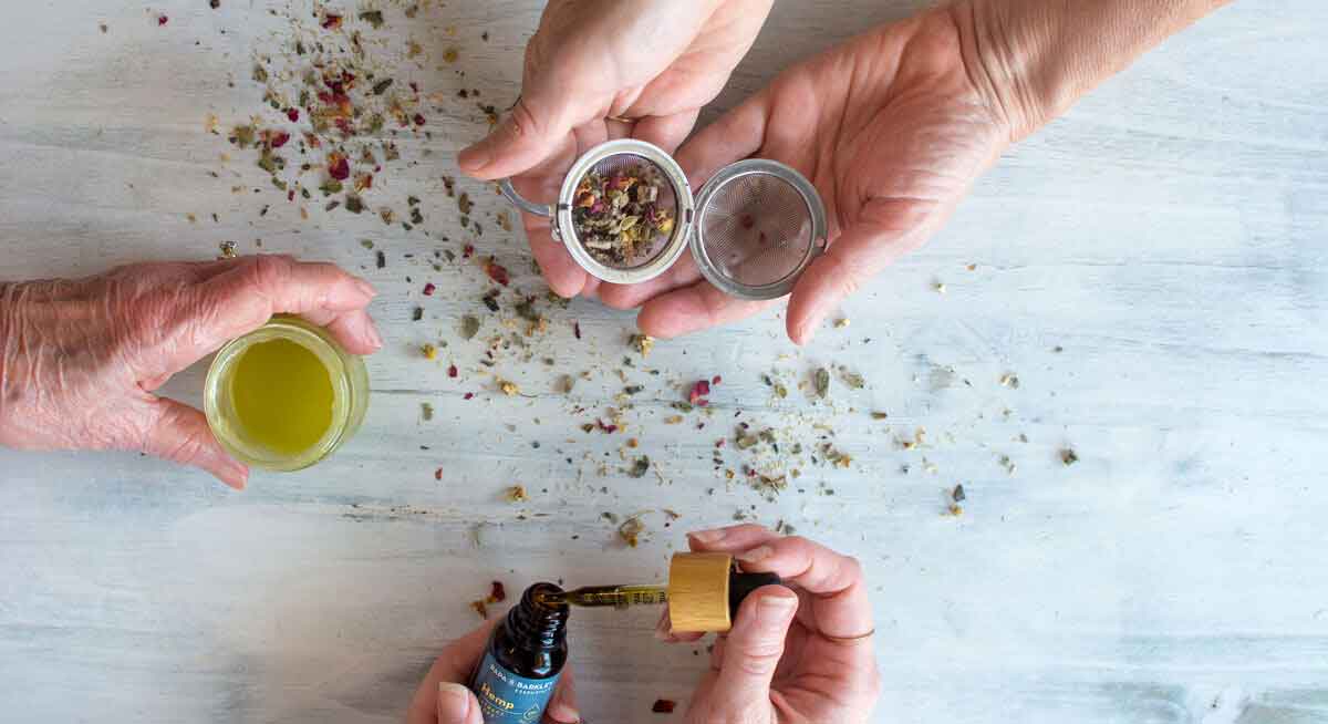 Hands of daughter, mother, grandmother holding various kinds of CBD products