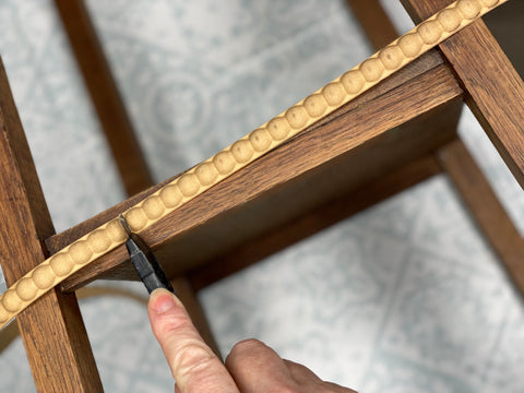 Beaded WUb trim being cut with craft knife