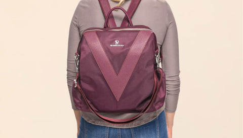 Image of a woman’s back with a convertible bag - convertible mini backpack