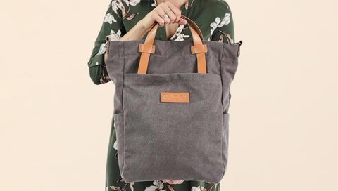 Woman carrying Converta convertible bag - sustainable crossbody bags