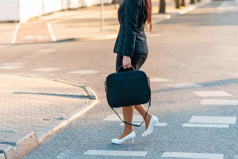 Woman carrying a laptop bag on the street - office bags for women