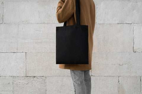 A woman carrying tote bag - work bag for women
