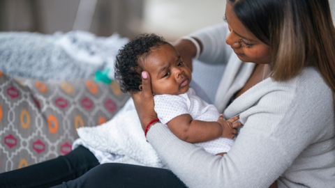 Mother holding her baby in great concern